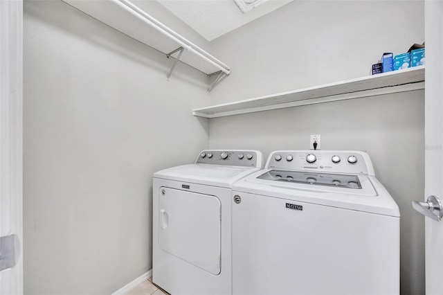 laundry area with washing machine and clothes dryer