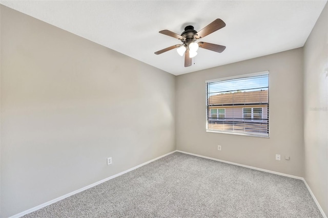 empty room with ceiling fan and carpet floors