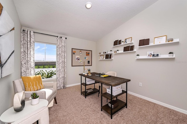 carpeted home office featuring lofted ceiling and a textured ceiling