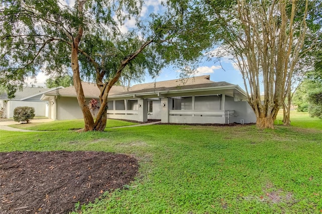 view of front of house featuring a front yard and a sunroom