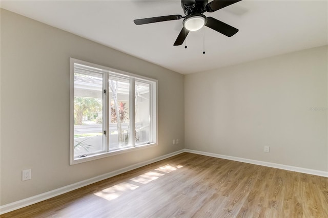 empty room featuring ceiling fan and light wood-type flooring