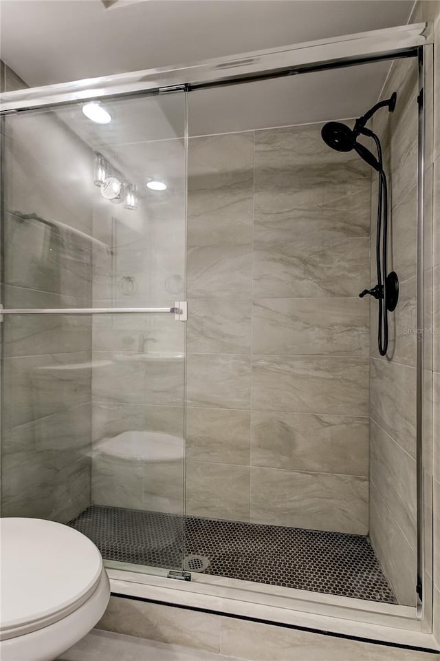 bathroom with walk in shower and toilet