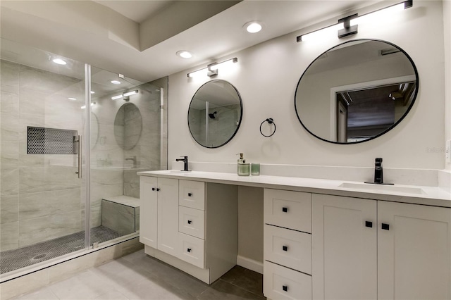 bathroom featuring walk in shower, vanity, and tile patterned floors