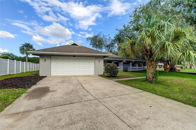 ranch-style home featuring a garage and a front lawn