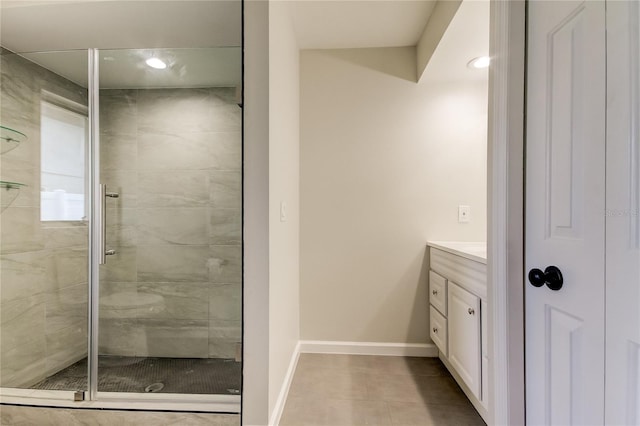 bathroom with vanity, a shower with door, and tile patterned floors