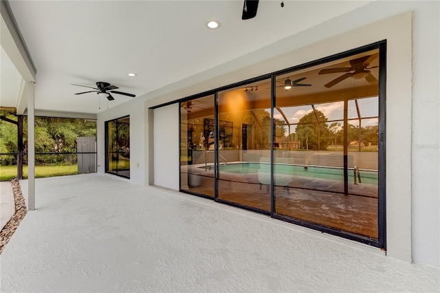 view of patio / terrace with a lanai and ceiling fan