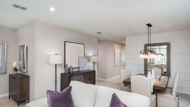 carpeted living room with a chandelier