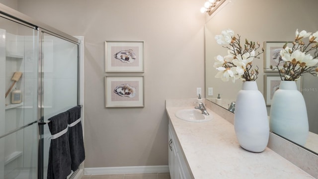 bathroom with tile patterned flooring, an enclosed shower, and vanity