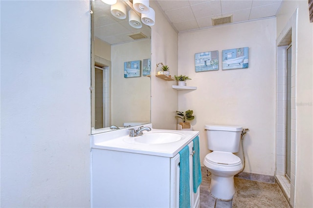 bathroom featuring vanity, a shower with shower door, toilet, and tile patterned flooring