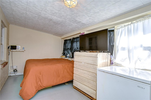 bedroom featuring white refrigerator