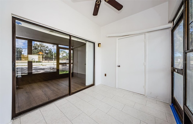 interior space with light hardwood / wood-style flooring, vaulted ceiling, and ceiling fan