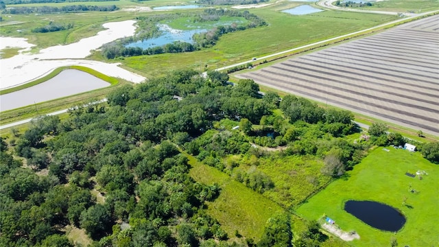 birds eye view of property with a rural view and a water view