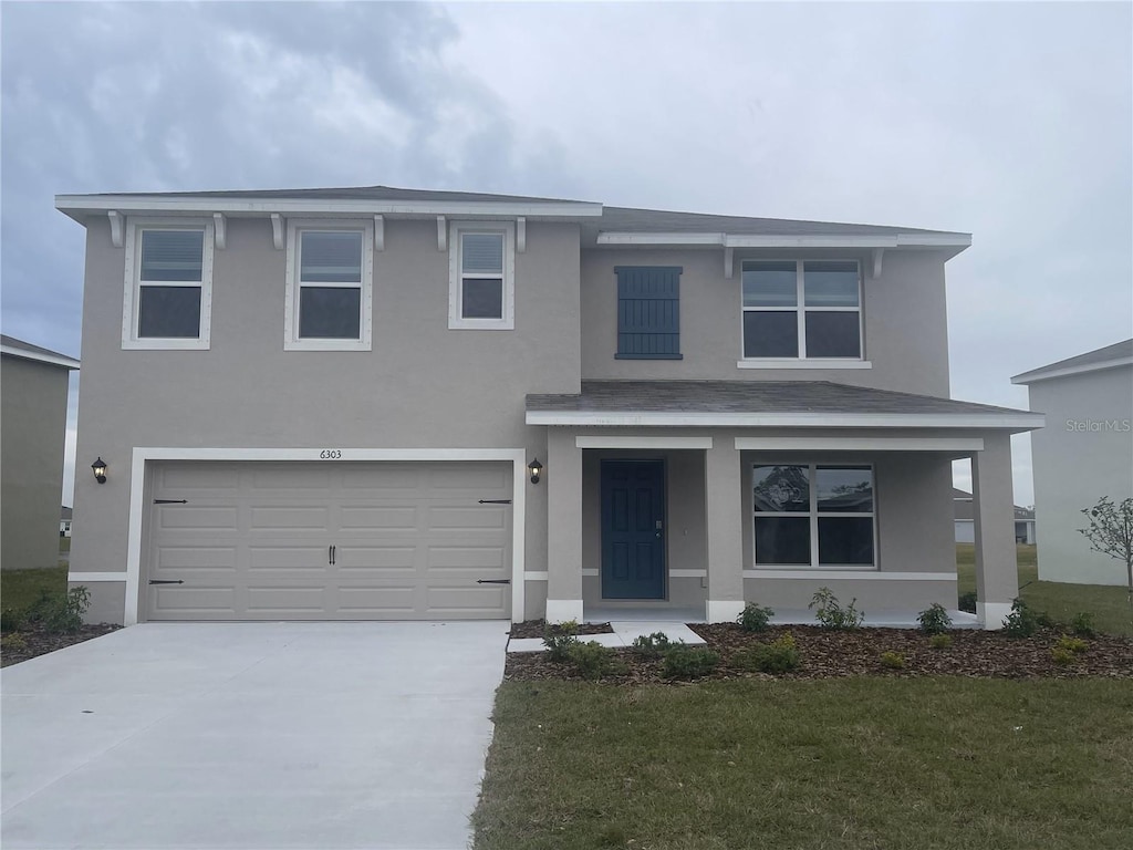 view of front facade featuring a garage and a front lawn