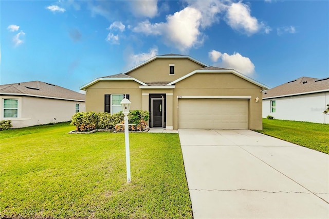 single story home featuring a garage and a front lawn