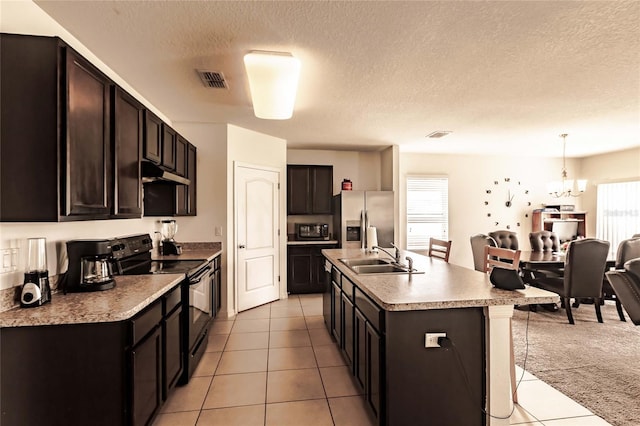 kitchen with sink, black appliances, pendant lighting, a chandelier, and an island with sink