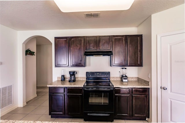 kitchen featuring dark brown cabinetry, light tile patterned floors, a textured ceiling, and black range with electric cooktop