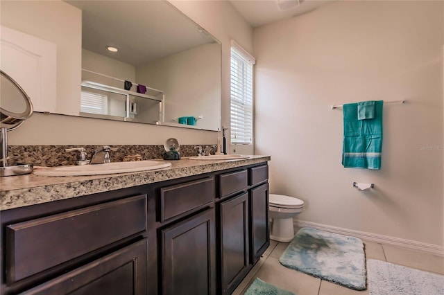 bathroom featuring tile patterned floors, vanity, and toilet