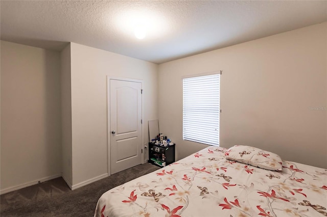 bedroom with dark colored carpet