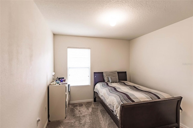 carpeted bedroom with a textured ceiling