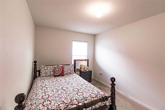 bedroom with carpet and a textured ceiling