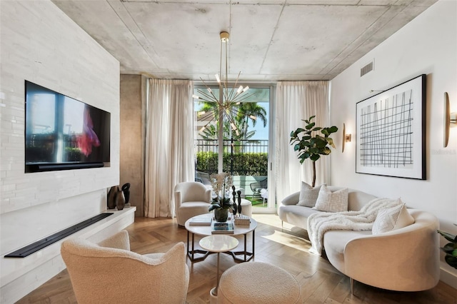 living room with wood-type flooring, an inviting chandelier, and a wealth of natural light