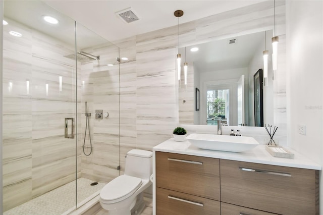 bathroom featuring walk in shower, vanity, and toilet