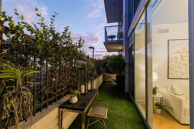 exterior space featuring a balcony and a yard