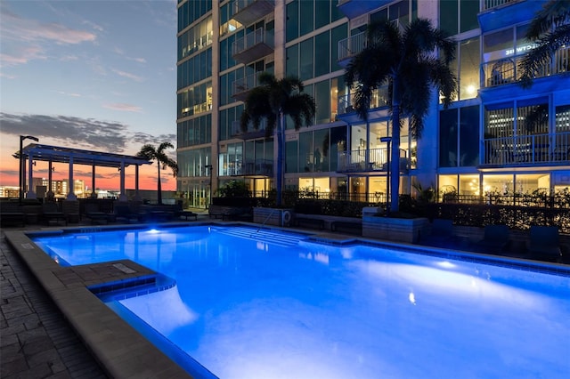 view of pool at dusk