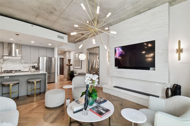 living room with a notable chandelier and light parquet flooring