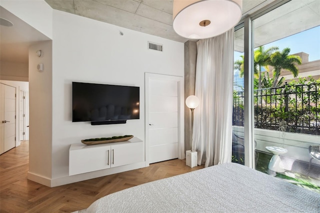 bedroom featuring parquet floors and access to exterior