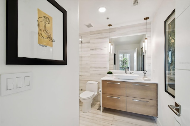 bathroom with tile walls, a shower, vanity, hardwood / wood-style flooring, and toilet