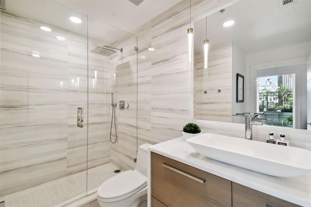 bathroom featuring walk in shower, vanity, and toilet