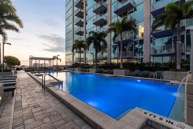 view of pool at dusk