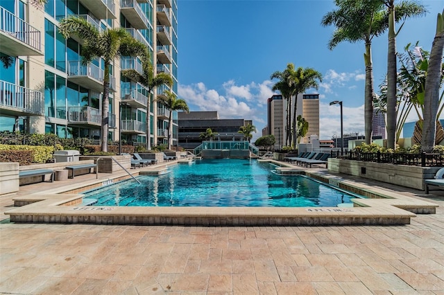 view of swimming pool with a patio and a jacuzzi