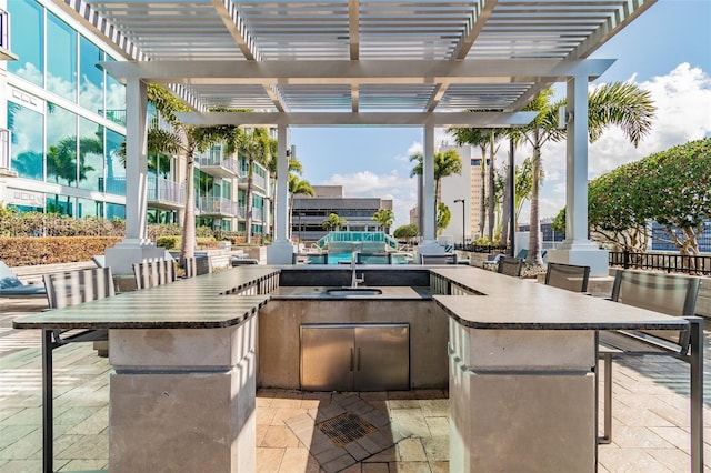 view of patio / terrace with a pergola and area for grilling