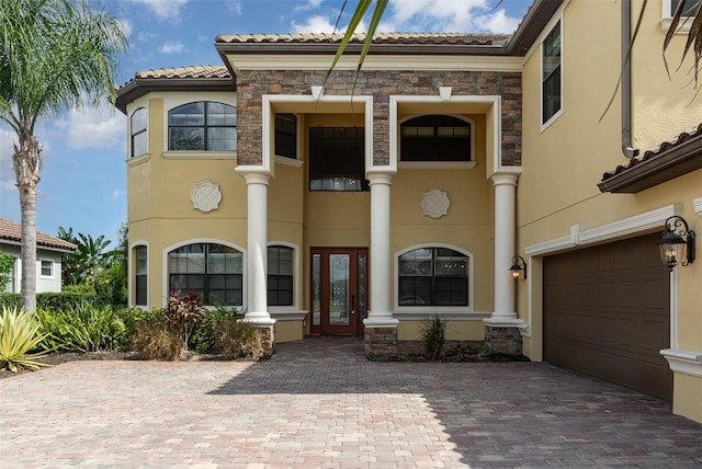 mediterranean / spanish home featuring a garage