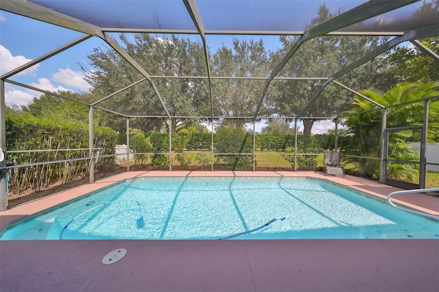 view of swimming pool featuring a lanai