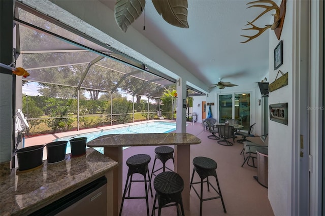 sunroom featuring a healthy amount of sunlight, a pool, and ceiling fan