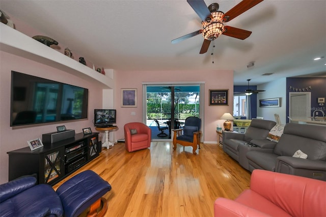 living room with ceiling fan, sink, and light hardwood / wood-style floors