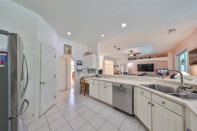 kitchen featuring ceiling fan, appliances with stainless steel finishes, sink, and a healthy amount of sunlight