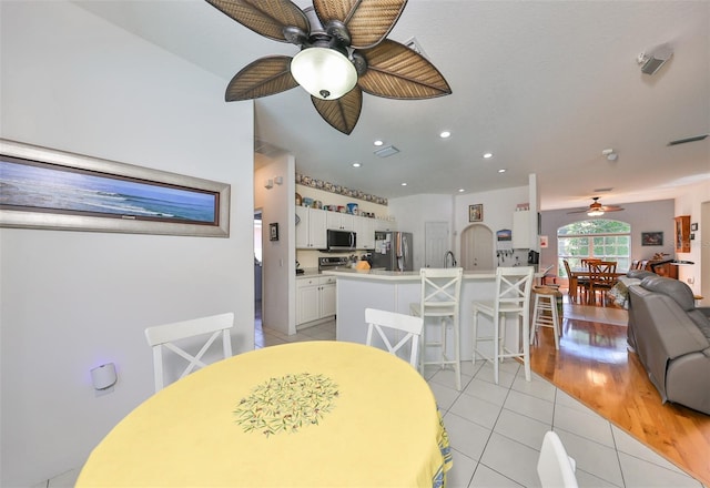 dining space featuring ceiling fan and light hardwood / wood-style flooring