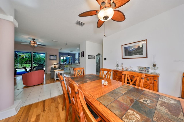 dining space with ceiling fan and light hardwood / wood-style floors