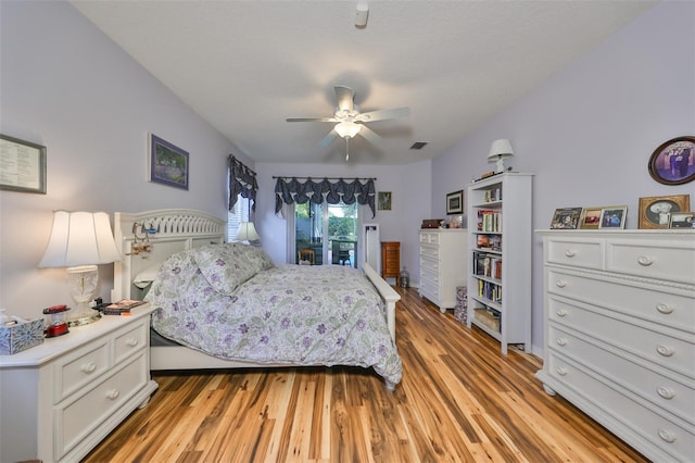 bedroom with light hardwood / wood-style floors and ceiling fan