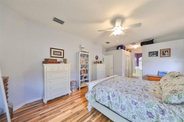 bedroom featuring ceiling fan, hardwood / wood-style flooring, a closet, and ensuite bath