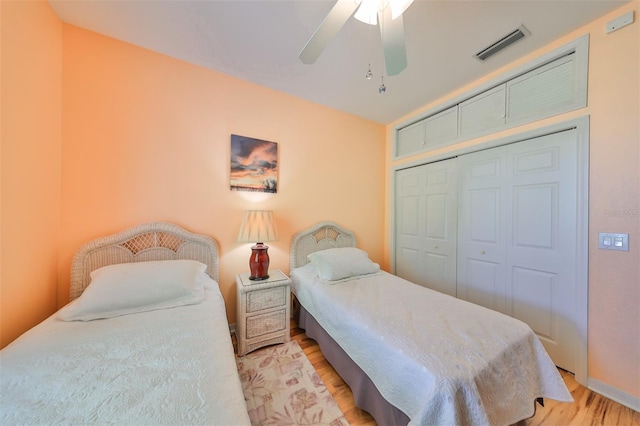 bedroom with ceiling fan, a closet, and light hardwood / wood-style flooring