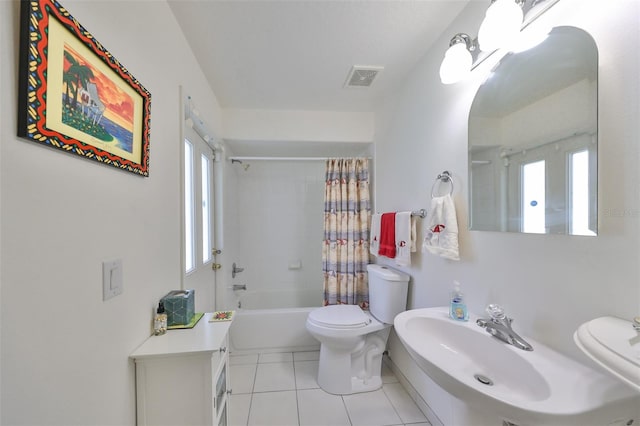 bathroom with shower / tub combo, toilet, and tile patterned floors