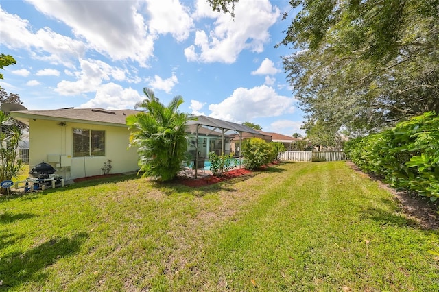 view of yard featuring a lanai and a swimming pool