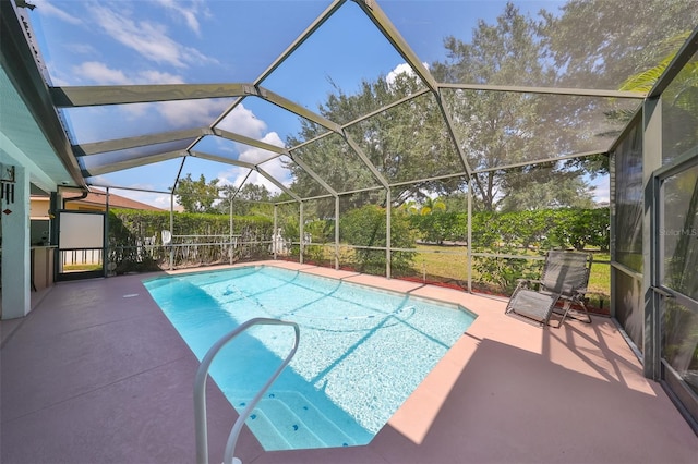 view of pool featuring glass enclosure and a patio area