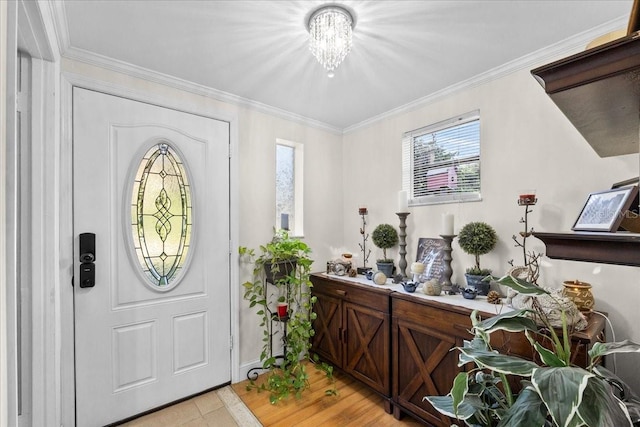 foyer featuring a notable chandelier and crown molding