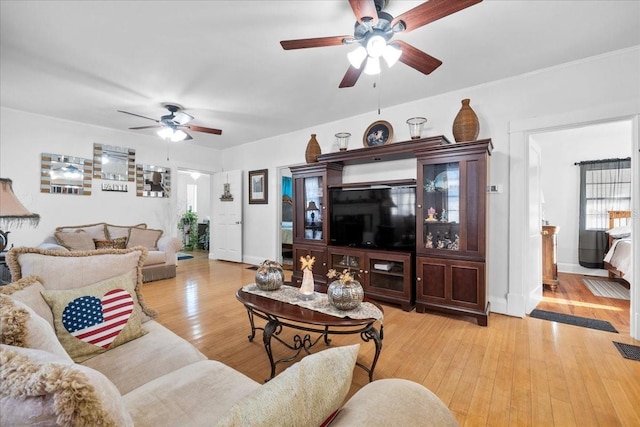 living room featuring ceiling fan and light wood-type flooring